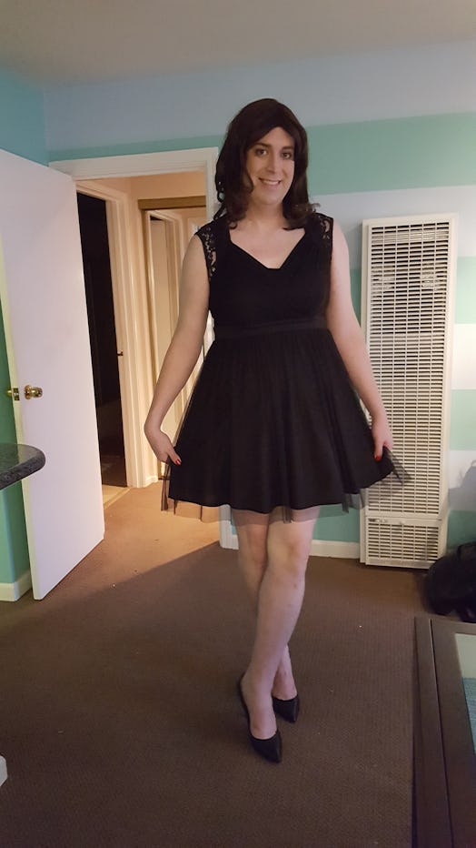 A transgender mom, Katelyn Burns, posing in a black cocktail dress