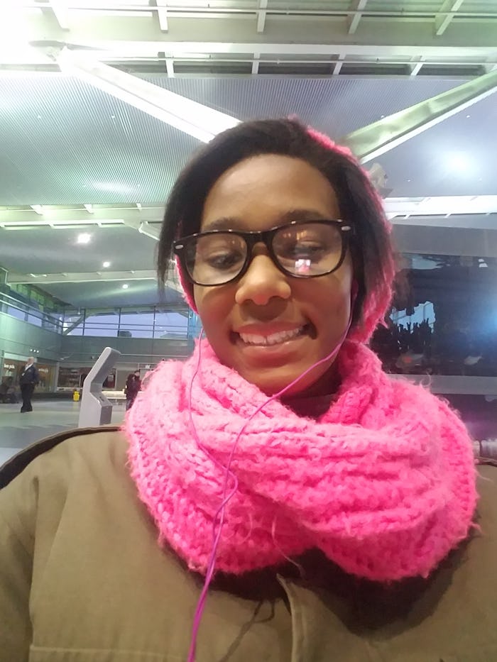 Sa'iyda Shabazz standing outside on a winters day with a large pink knitted scarf