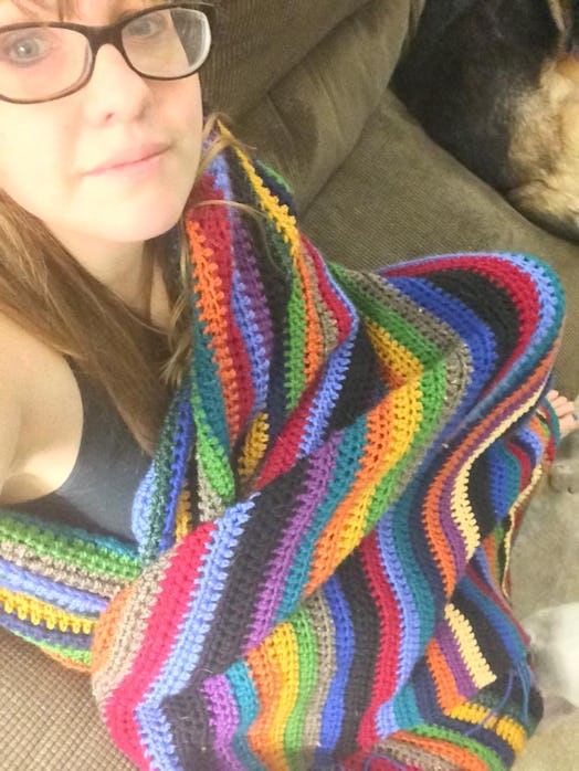 Woman with glasses and a colorful blanket