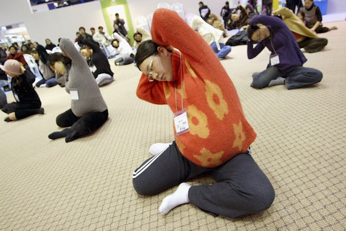A group of pregnant women doing stretching together at a rec center