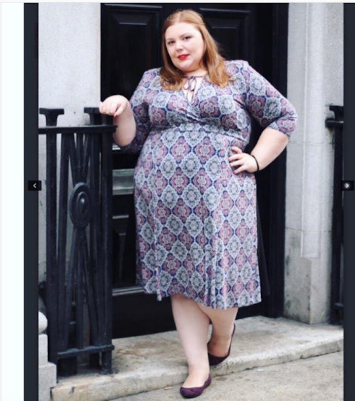 Hollie Burgess postpartum posing while wearing a midi patterned dress