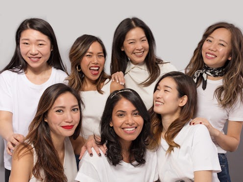 The six Asian women posing together in white shirts