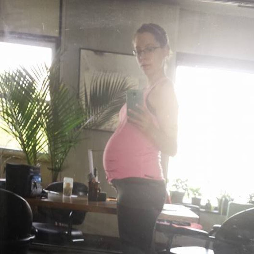 Mary taking a mirror selfie while pregnant  