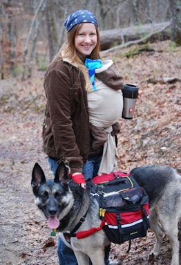 Happy mom, her baby and dog posing for a picture in the forest