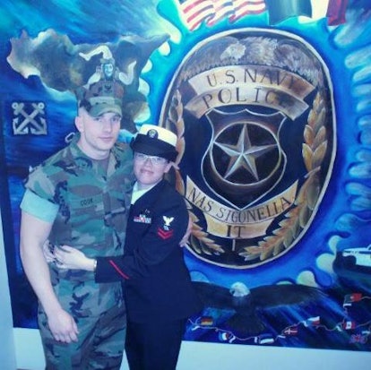 Stephanie Baroni Cook  in her uniform taking a picture with her husband 
