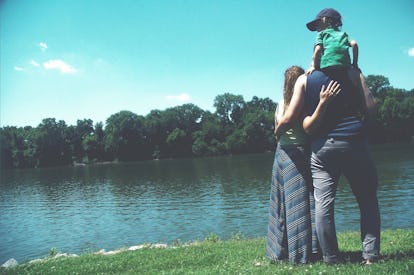 A pre-diabetic woman and her family are standing in front of the lake