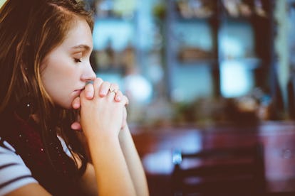 A pre-diabetic woman holding her hands to her face trying to brace herself due to her dizziness