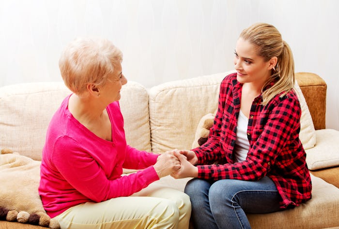 Woman holding hands with her mother-in-law