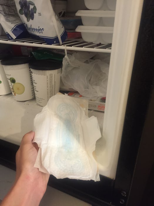 A woman putting a pad in the fridge