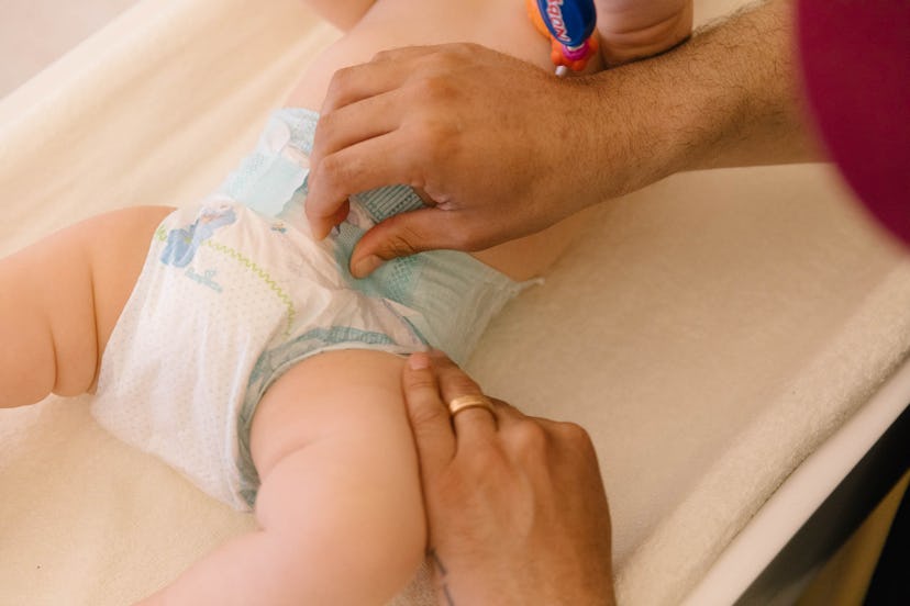 A nurse changing diapers of a baby