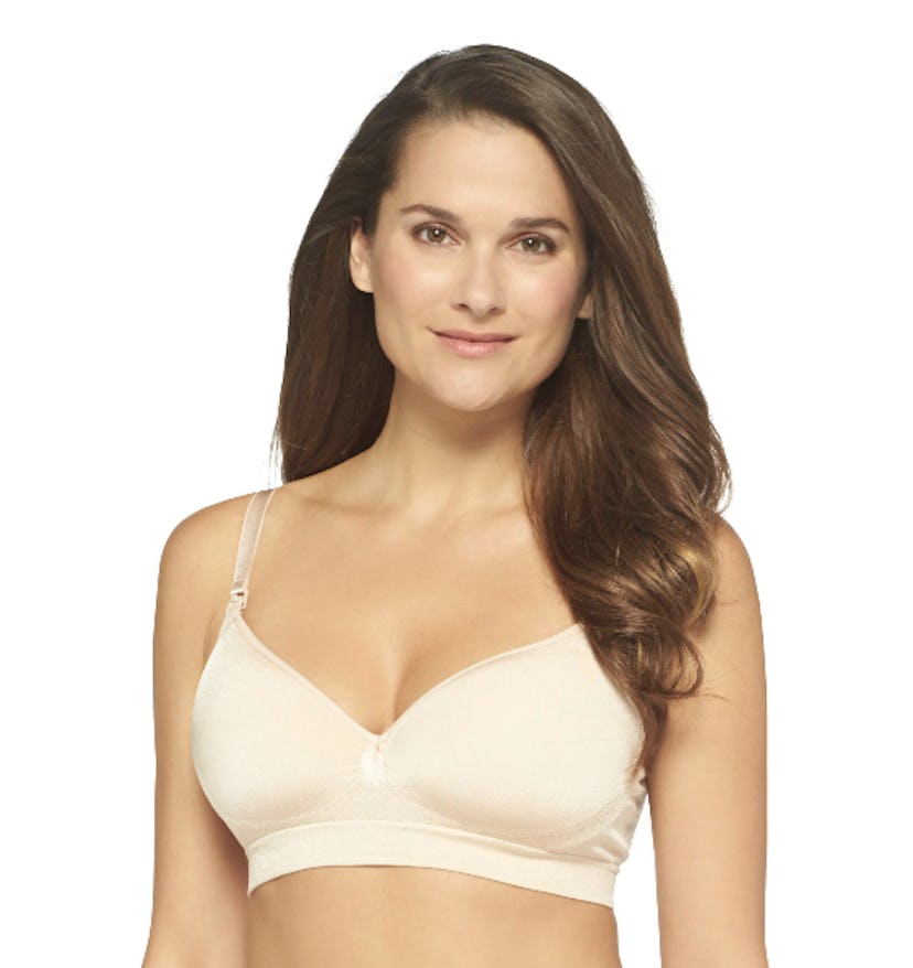 A woman wearing a beige nursing seamless bra.