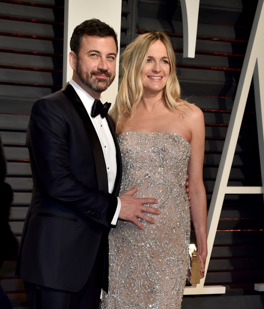 Jimmy Kimmel with his hand on his pregnant wife Molly's belly on the red carpet