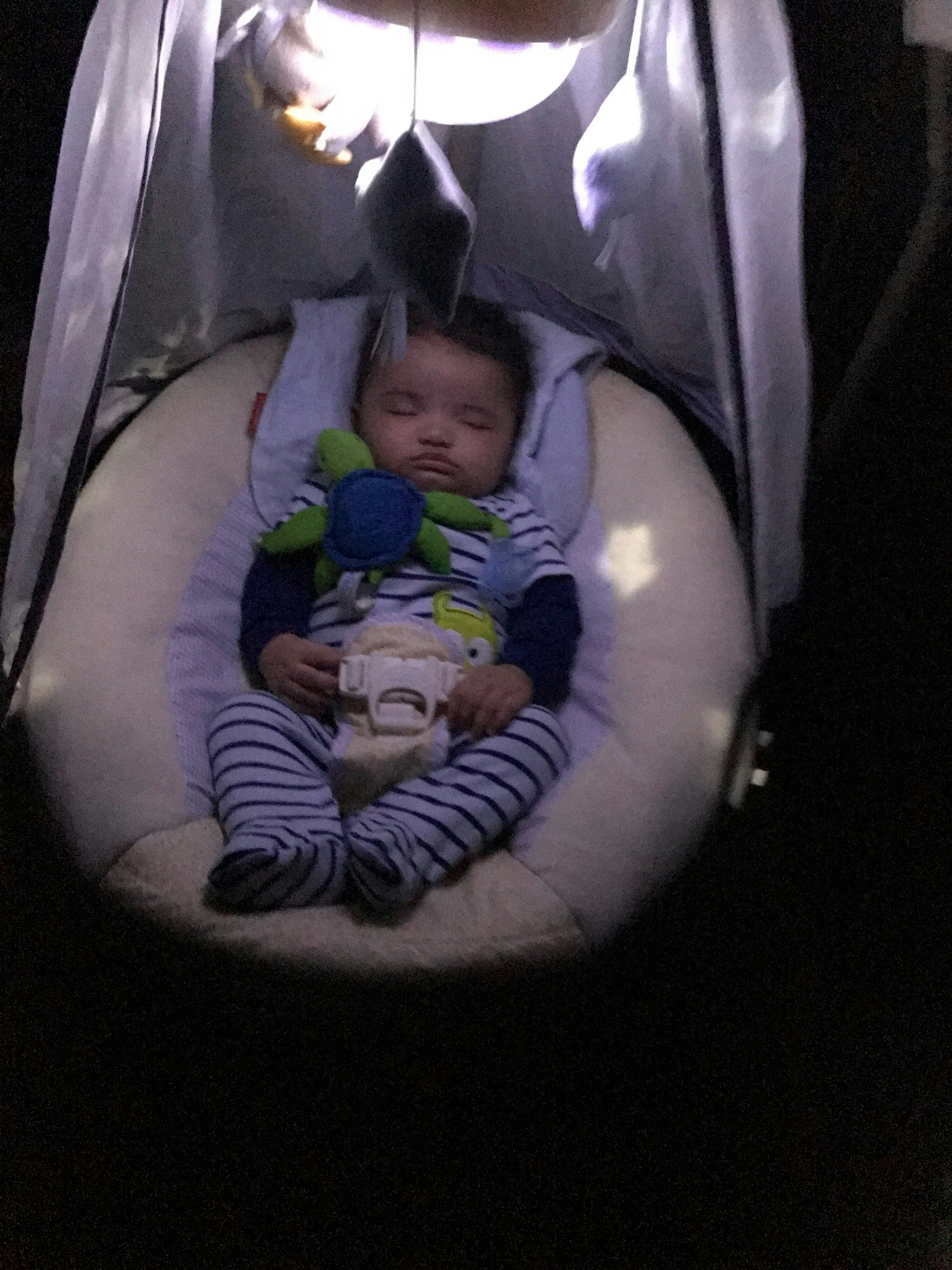 infant sleeping in swing