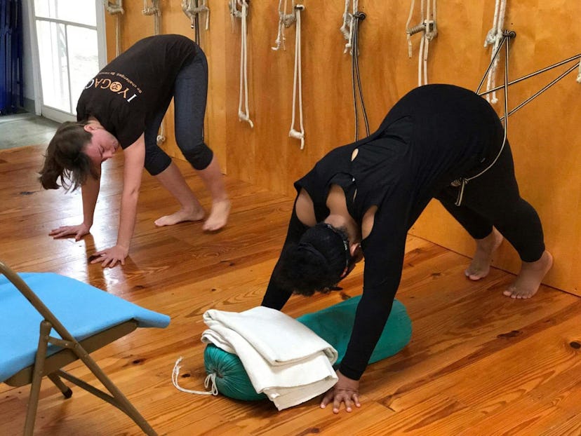 Kelly doing stretching with Gwendolyn, a certified yoga teacher.