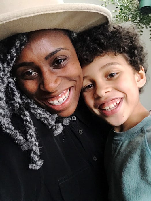 Happy black mother posing with her curly hair smiling son