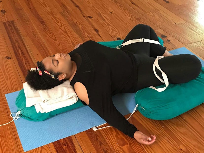 Kelly doing Supported Supta Baddha Konasana yoga pose.