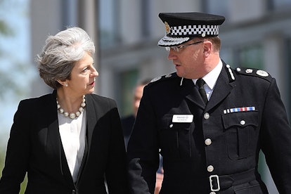 Theresa May talking with a police officer in Manchester 