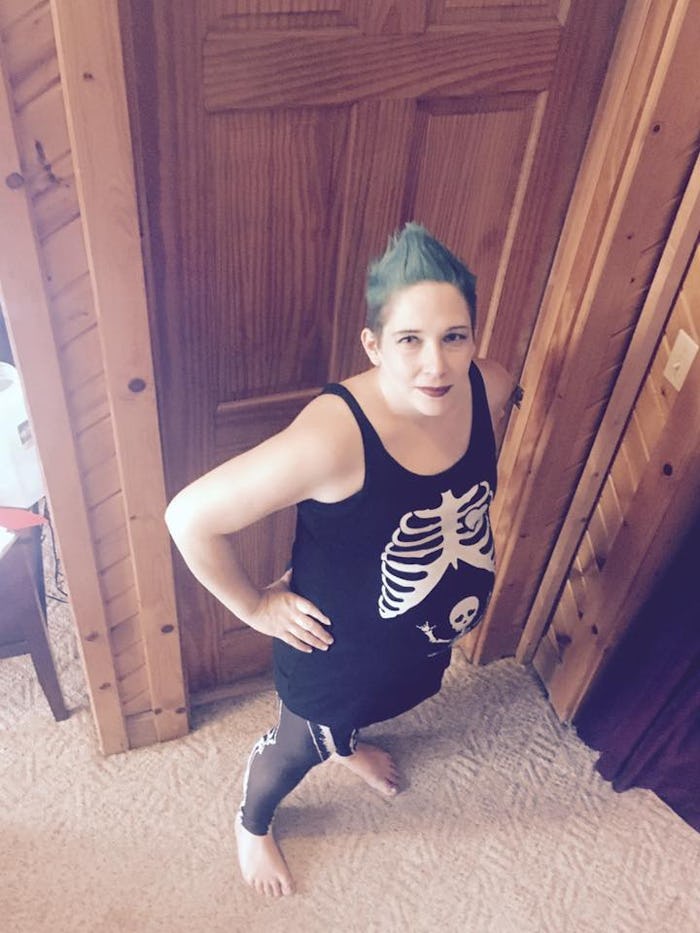 A woman in a skeleton tank top staring up at the camera