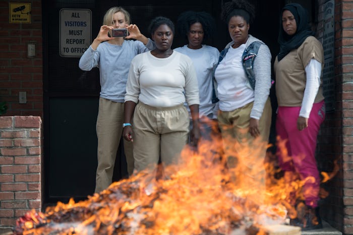 The cast of Orange is the New Black season 4 watching a fire in an episode of the show 