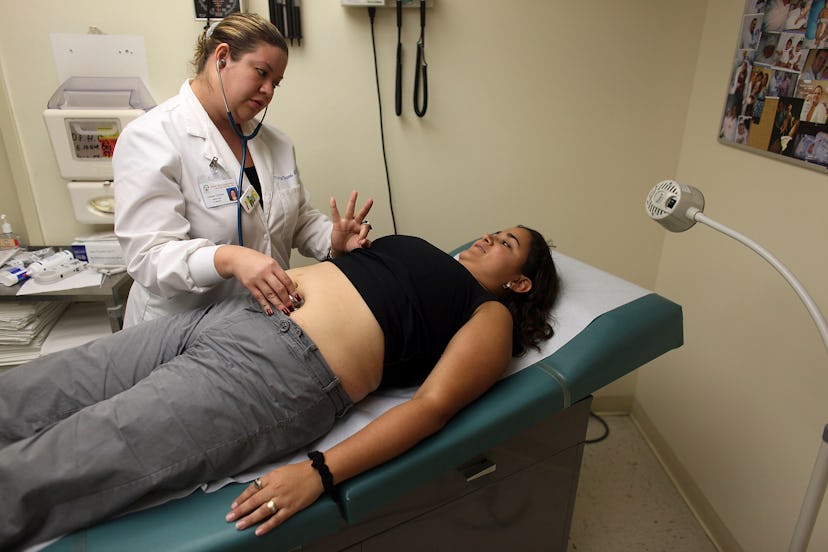 A woman with preeclampsia at a gynecologists' office getting an ultrasound 