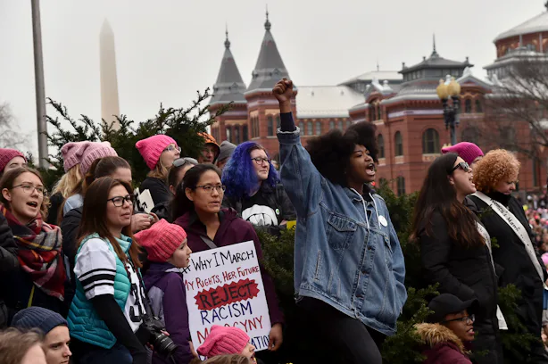 A close-up of a woman’s face in 2017, her expression a mix of defiance and exhaustion, foreshadowing the complexities of 2026’s gender debates.