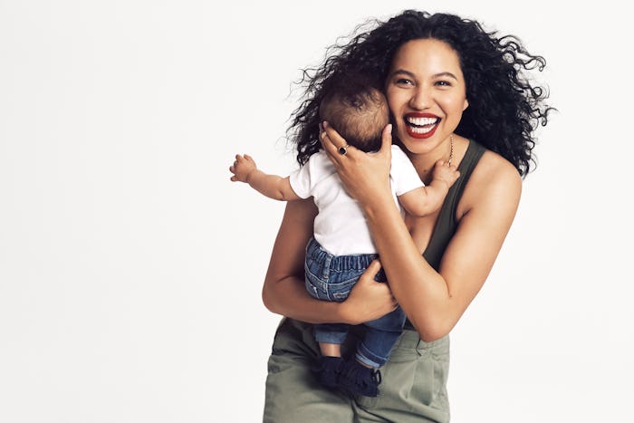 Jurnee Smollett-Bell posing for a photo while holding her baby son