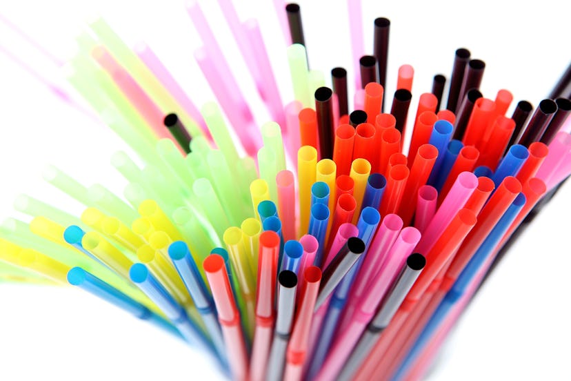 Plastic straws in pink, black, blue, violet, green and yellow