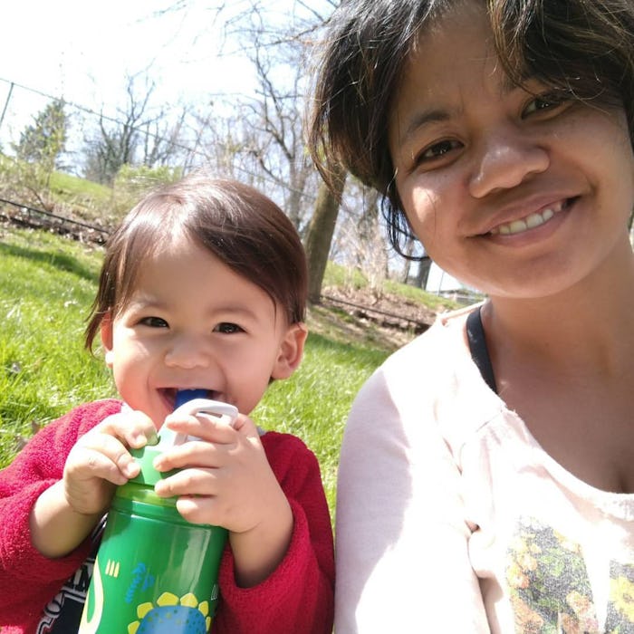 A mother taking a selfie with her toddler child