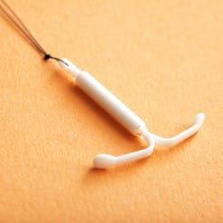 An IUD placed on an orange surface