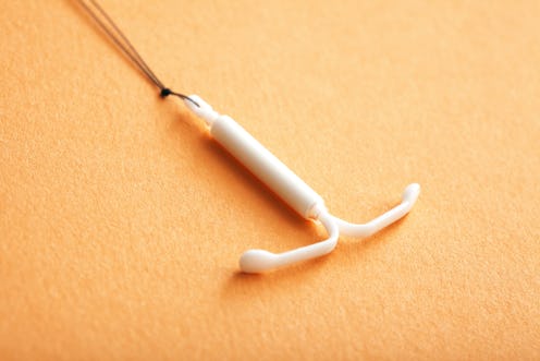 An IUD placed on an orange surface