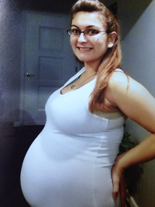 A pregnant lady, visibly happy because she is expecting twins