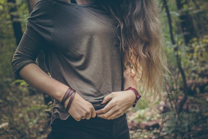 Blonde woman adjusts her pants at waist height and she has IBS