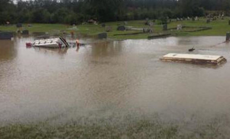 record breaking flooding is causing coffins to come out of the ground