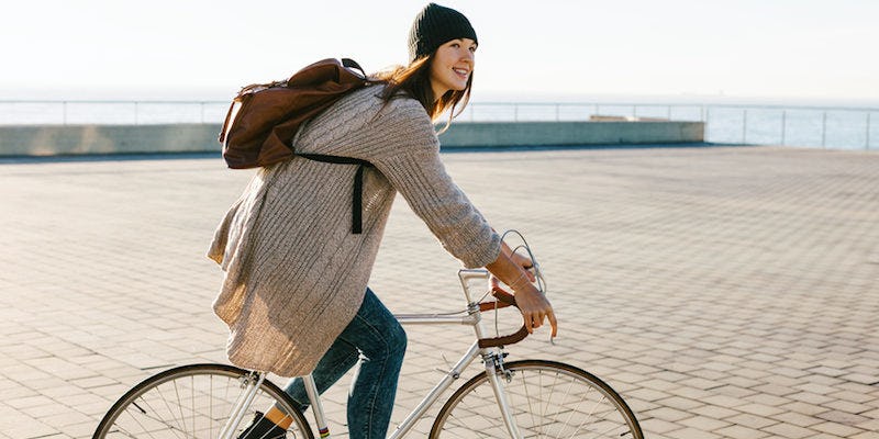 A woman riding a bike to work as a way of switching up her daily commute