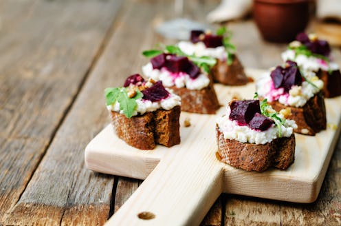 A goat cheese, celery, and salad pieces on small baguette slices