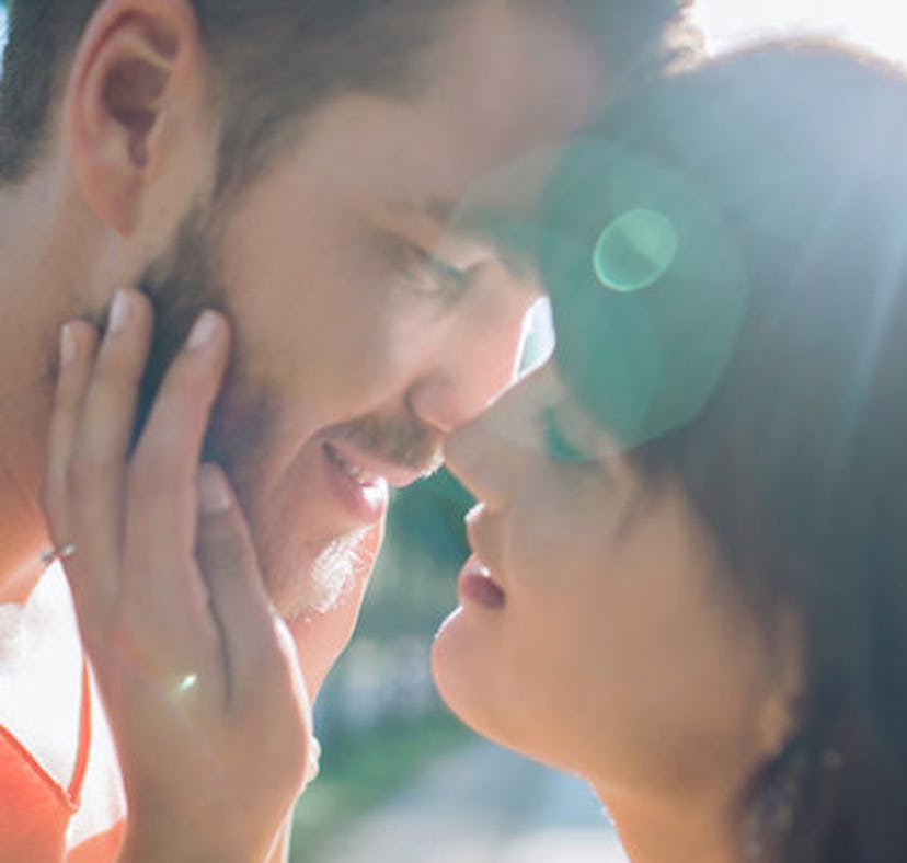 A girl knows her partner is crazy about her and kisses him on the lips.