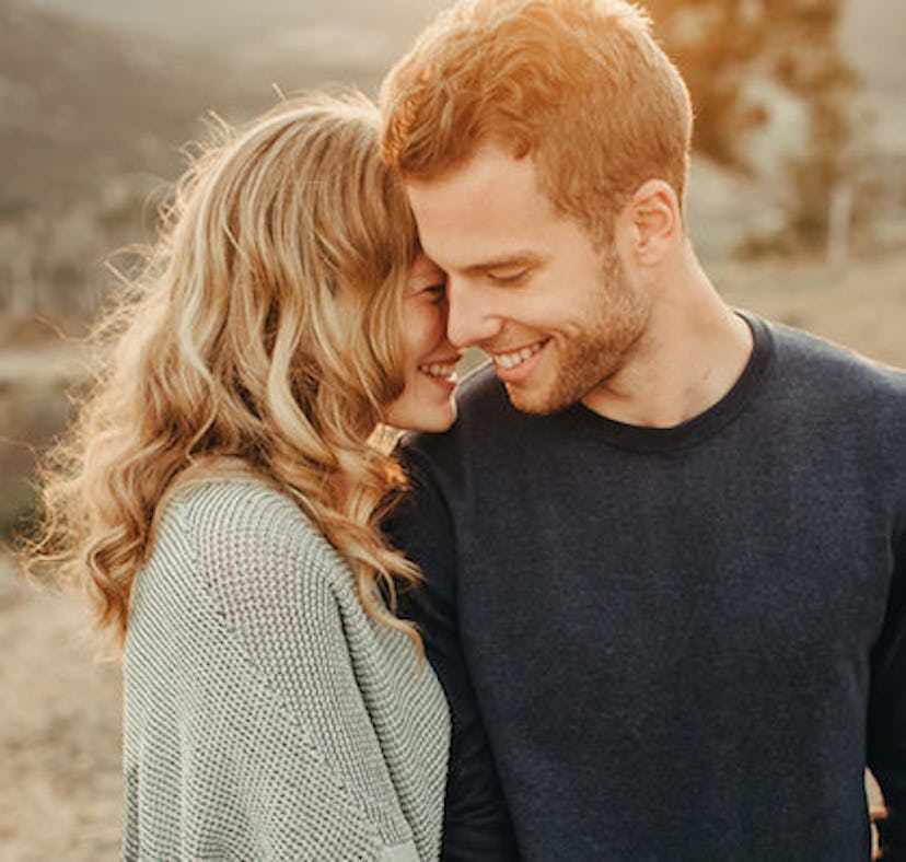 A Pisces whispers affection into their partner's ear.