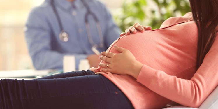 A pregnant teen at doctor's appointment.