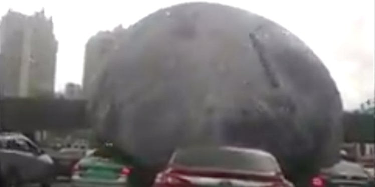 A giant moon balloon in China steamrolling over people and cars on the road