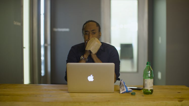 A man breathing into a brown paper bag to de-stress after the elections