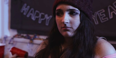 A brunette woman with social anxiety and a black beanie looking anxious