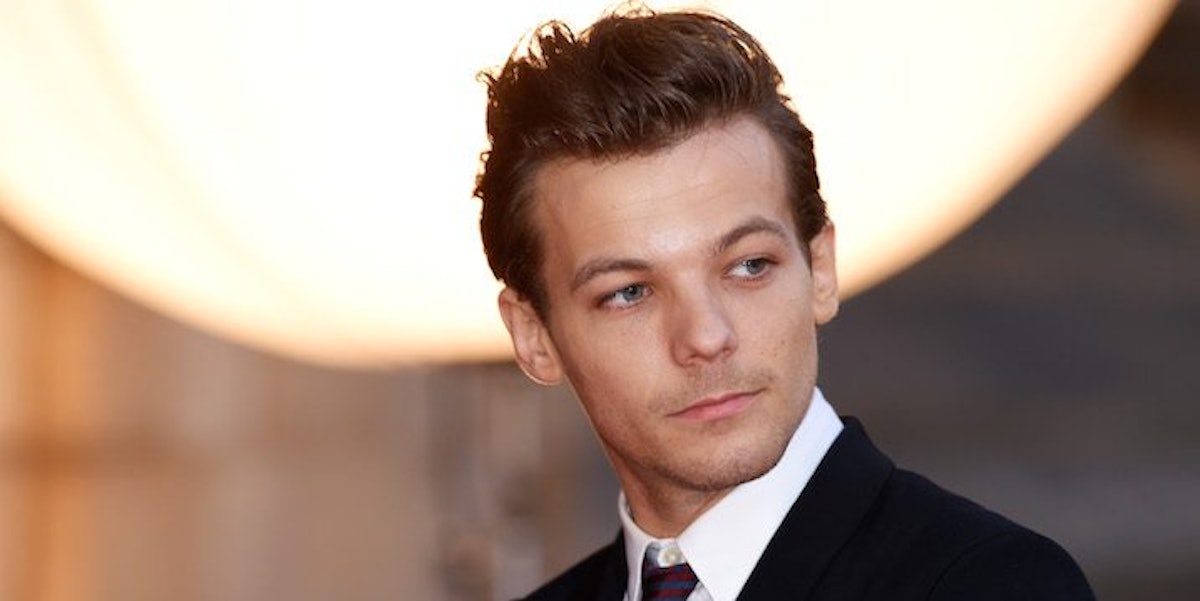 Louis Tomlinson Arrested For Attacking Paparazzo In Airport
