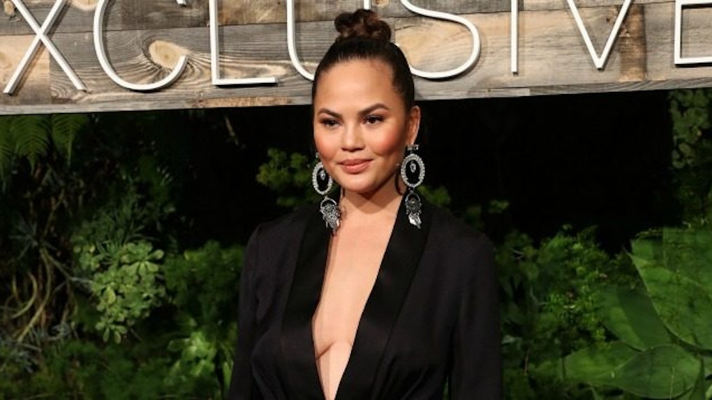 Chrissy Teigen Struggles To Zip Her Boobs Into A Jumpsuit