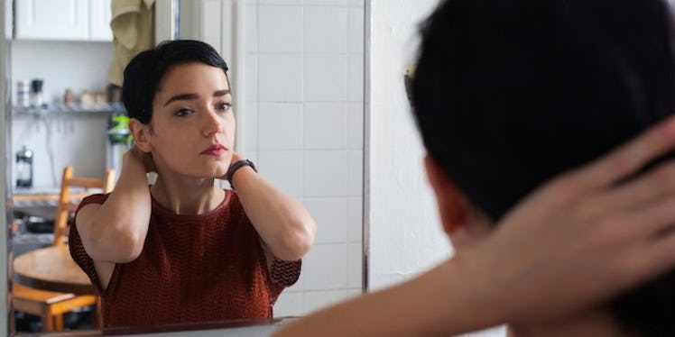 A brunette woman with social anxiety not sure how to handle going on a date and looking at herself i...
