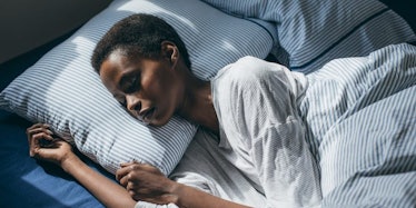 A young woman sleeping in her bed