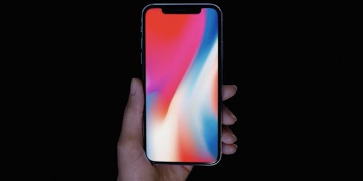 A person holding an iPhone X in its hand