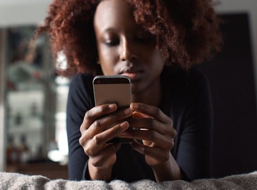 A woman stares at her phone. Here's what it means if your partner is texting you less often.