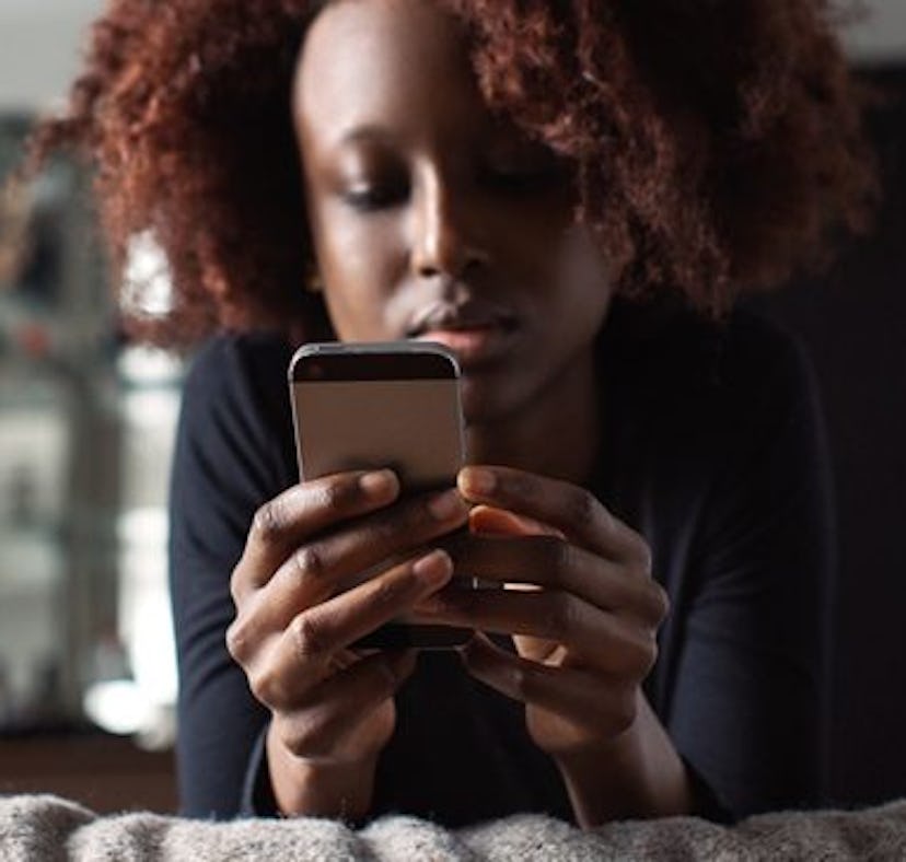 A woman stares at her phone. Here's what it means if your partner is texting you less often.
