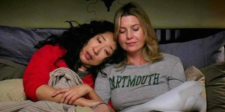 Grey's Anatomy's Cristina Yang (Sandra Oh) leaning on her best friend Meredith Grey (Ellen Pompeo) t...