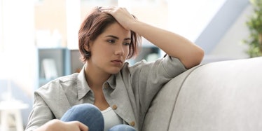 A depressed woman sitting on a couch